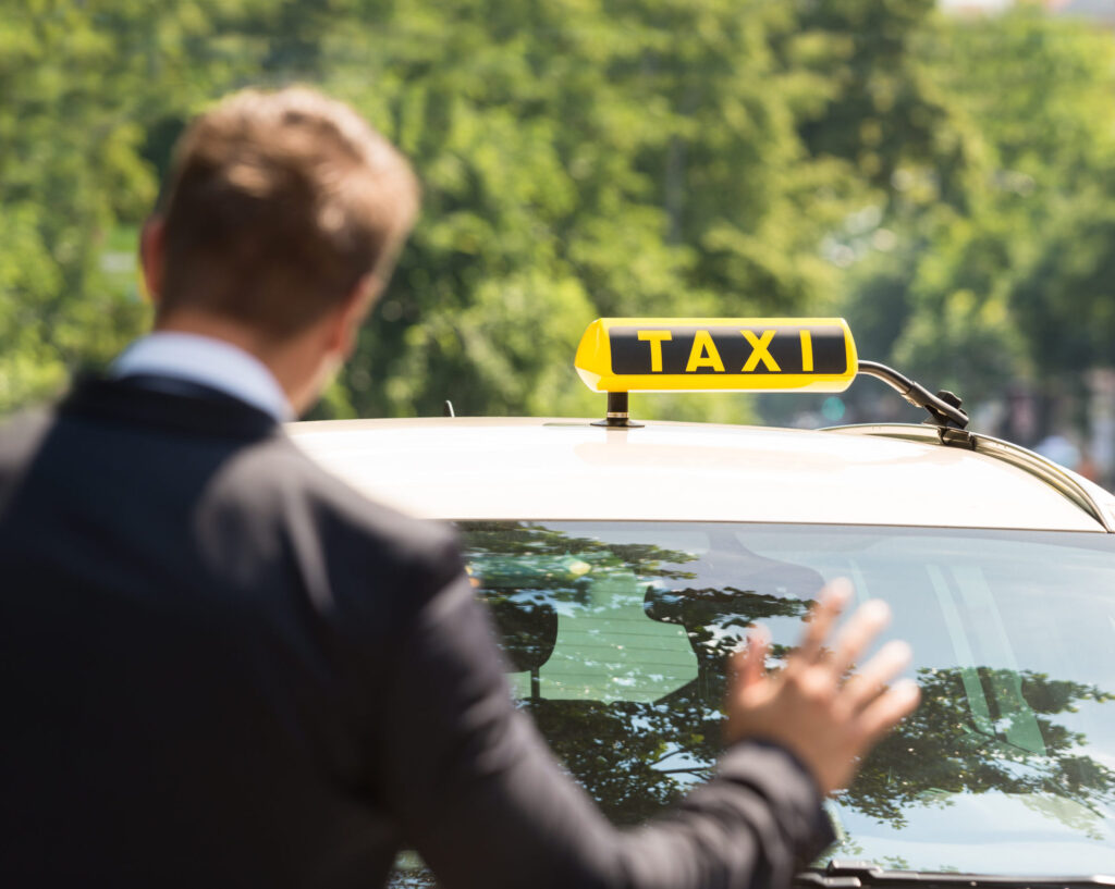 Close-up Photo Of A Businessman Calling Taxi